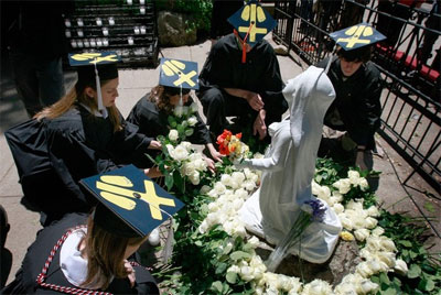 Notre Dame University students lay roses at a statue of Mary during an alternative commencement cermony held to protest President Barack Obama's visit to the Grotto of Our Lady of Lourdes on the campus of Notre Dame University May 17, 2009 in South Bend, Indiana. Source: Getty Images